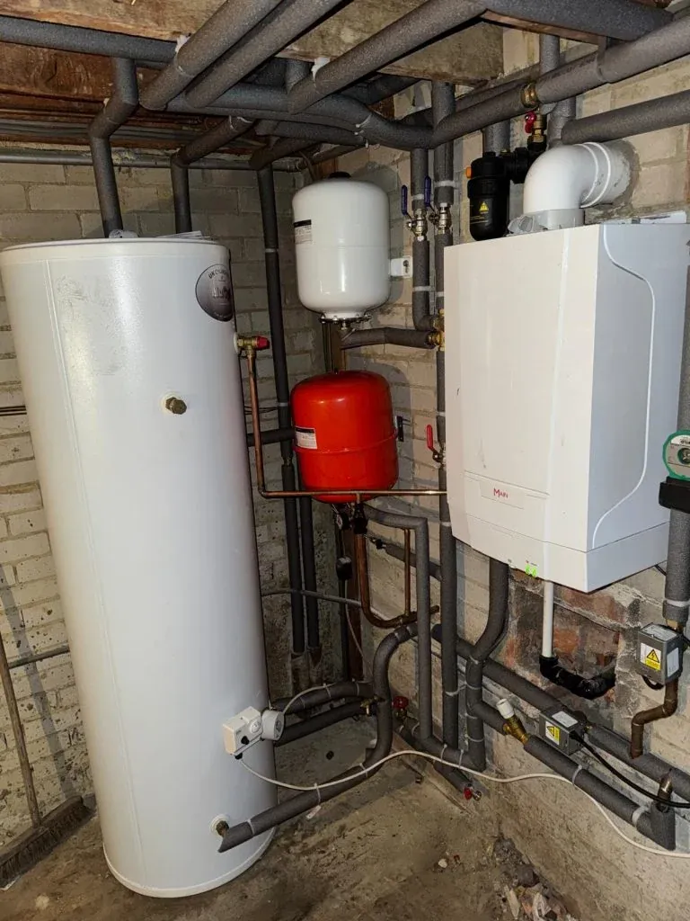 Hot water cylinder, boiler and heating system pipework